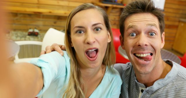 Happy Couple Making Funny Faces While Taking Selfie Indoors - Download Free Stock Images Pikwizard.com