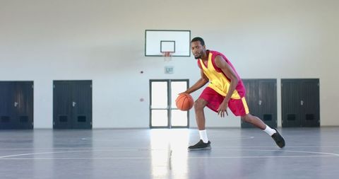 Athletic Man Demonstrating Basketball Skills Indoors