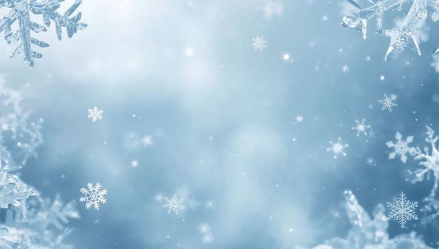 Drifting snowflakes creating soft blue frosted bokeh backdrop with crystal edges