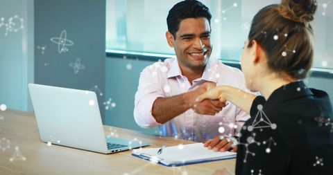 Business Partners Shaking Hands with Digital Elements Symbolizing Innovation