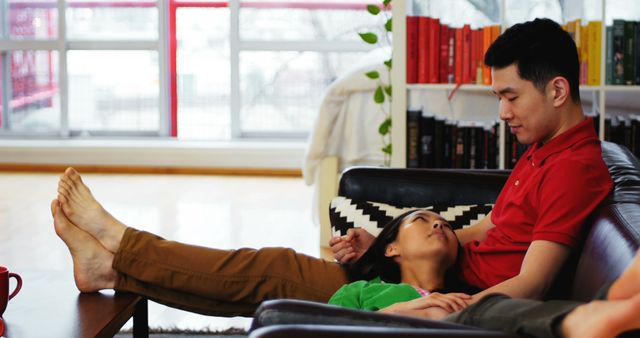 Couple relaxing on sofa in living room at home - Download Free Stock Photos Pikwizard.com