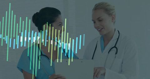 Two medical professionals reviewing patient chart with digital waveform data overlay