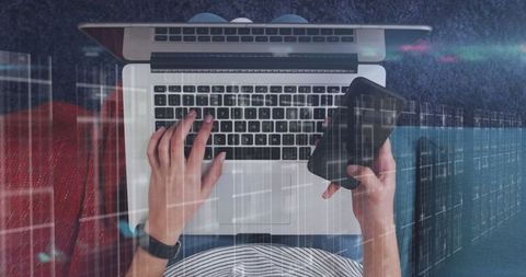 Person analyzing data on laptop and smartphone interface