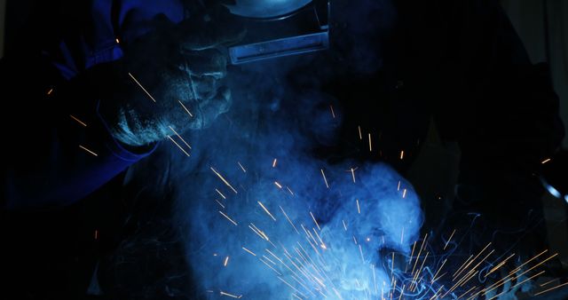 Close-Up of Welder Working with Sparks and Smoke - Download Free Stock Images Pikwizard.com