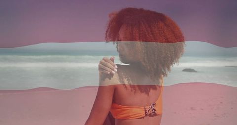 Relaxed Woman in Orange Bikini on Beach by Ocean Waves