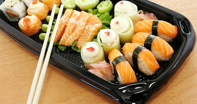 Assorted Sushi Platter with Nigiri and Rolls on Wooden Table - Download Free Stock Images Pikwizard.com