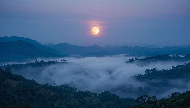 Mystical Full Moon Over Foggy Mountain Landscape at Twilight