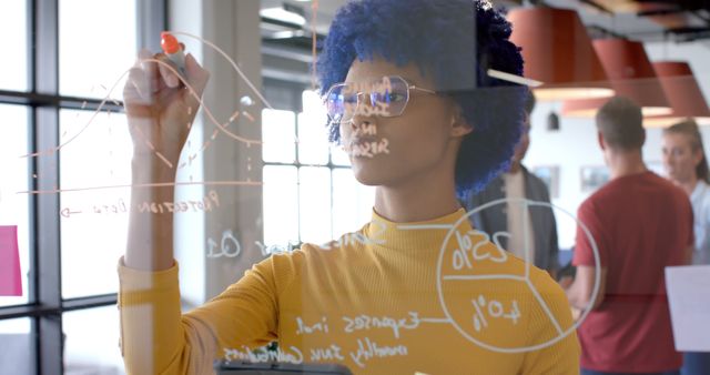 Focused Businesswoman Writing on Transparent Board in Modern Office - Download Free Stock Images Pikwizard.com