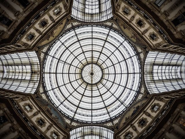 Glass dome ceiling within a historic building displaying intricate geometric patterns and symmetrical design. Ideal for architectural blogs, heritage preservation projects, interior design inspiration, academic presentations on historic structures, and promotional material for cultural landmarks.