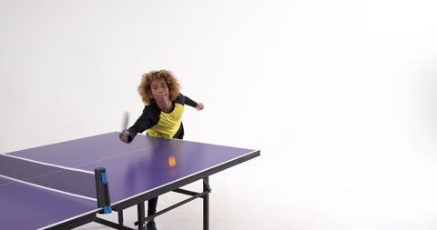 Woman playing table tennis demonstrating focus and skill