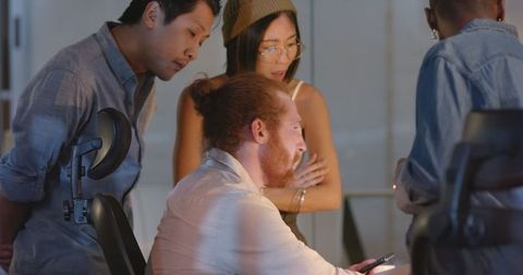 Diverse team engage in animated office collaboration