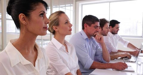 Diverse Team Focusing in Modern Meeting Room Collaboration