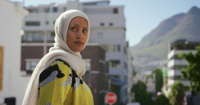 Confident Muslim Woman in Urban Streetscape with Mountain View - Download Free Stock Images Pikwizard.com