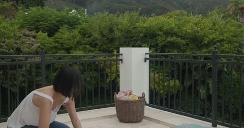 Woman Preparing for Outdoor Picnic in Garden with Wine and Snacks