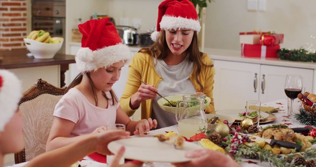 Family Enjoying Christmas Dinner with Santa Hats and Holiday Decorations - Download Free Stock Images Pikwizard.com