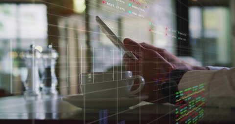 Businessperson Using Tablet with Financial Data Overlay