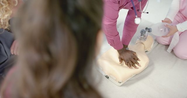 African american male doctor practicing cpr with diverse trainee doctors at hospital - Download Free Stock Photos Pikwizard.com