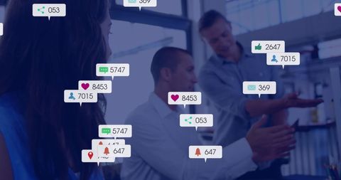 Business colleagues engaging in discussion with social media graphics