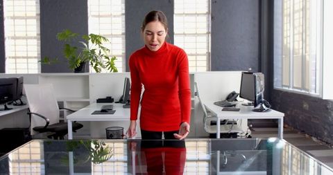 Businesswoman in Red Sweater Leading Office Meeting
