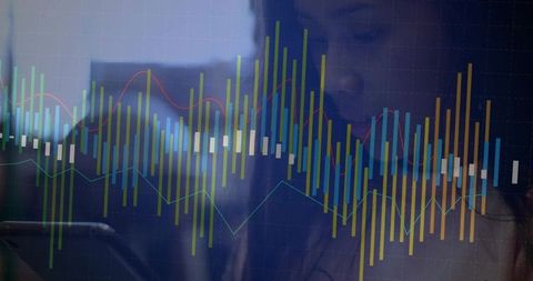 Businesswoman Analyzing Financial Data on Tablet with Transparent Charts