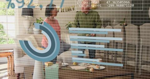 Senior couple standing in living room sharing pastries and conversation with data overlay