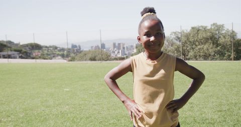 Smiling Young African Girl on Sunny Field Enjoying Summer Day