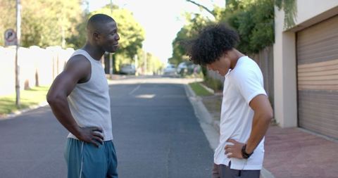 Diverse Male Friends Enjoy Outdoor Workout Break on Suburban Street