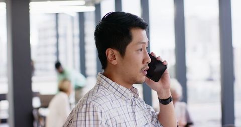 Focused business professional engaged in phone conversation