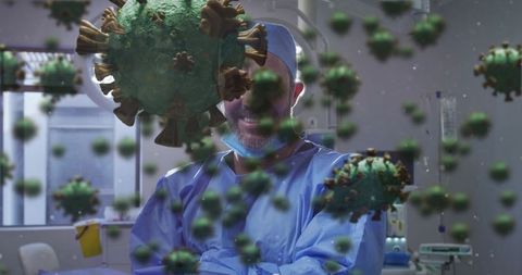 Surgeon standing in hospital room crossing arms wearing blue scrubs with virus overlay