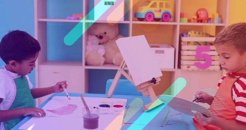 Young boys painting together in colorful classroom art activity encouraging creativity