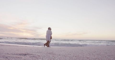 Elderly Couple Enjoying Romantic Walk on Scenic Beach at Sunset - Download Free Stock Images Pikwizard.com