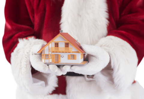 Santa holding transparent tiny house for christmas concepts