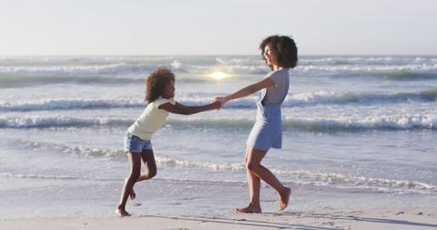 Mother and Daughter Dancing on Sandy Beach at Sunset - Download Free Stock Images Pikwizard.com