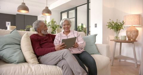 Happy Senior Couple Using Tablet for Video Call in Cozy Living Room - Download Free Stock Images Pikwizard.com