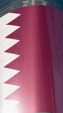 Vertical panning centering maroon curved tower panel with serrated white stripe and sun glare