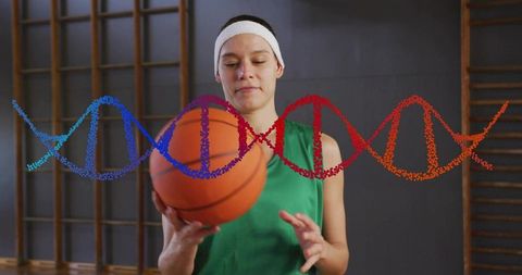 Female basketball player holding ball with dna helix overlay representing sports genetics