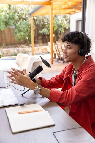 Young Man Podcasting Outdoors with Modern Equipment