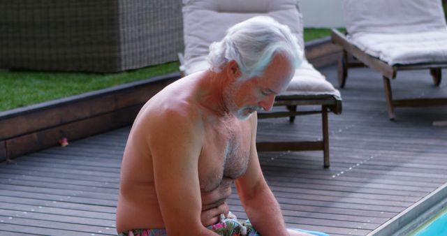 Elderly Man Relaxing by Pool in Outdoor Setting - Download Free Stock Images Pikwizard.com