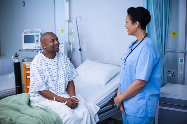Nurse engaging in conversation with patient in hospital ward. Ideal for healthcare, medical care, patient support, hospital services, and nursing profession themes.