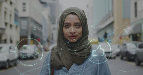 Smiling Woman in Hijab Surrounded by Digital Icons, Embracing Technology
