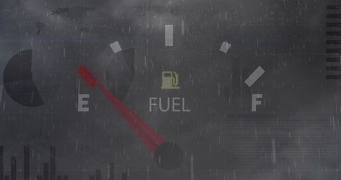 Low Fuel Warning on Stormy Background with Stock Market Data