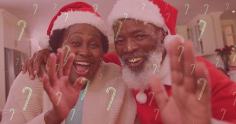 Smiling couple in santa hats celebrating christmas joyfully