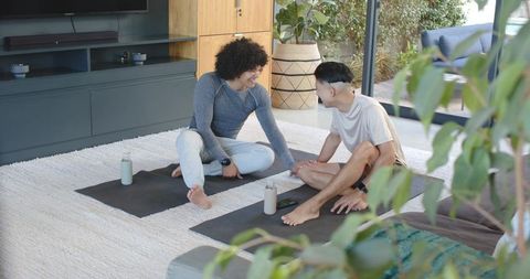 Diverse Friends Engaging in Home Yoga Practice Together