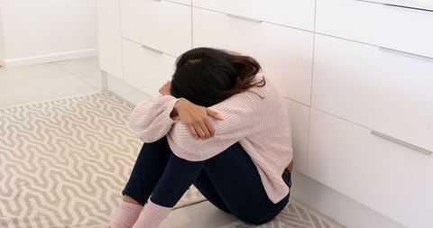 Woman contemplating in modern minimalist kitchen at home
