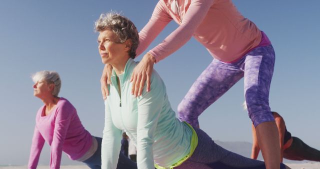 Senior women participating in an outdoor yoga session with an instructor. Perfect for use in articles, blogs, and advertisements highlighting fitness and health activities for elders, wellness programs, and the benefits of outdoor exercises.