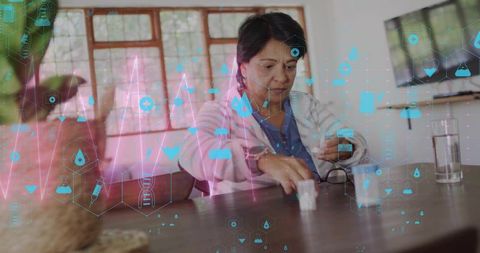 Senior indian woman managing medication with telehealth monitoring and health data overlay