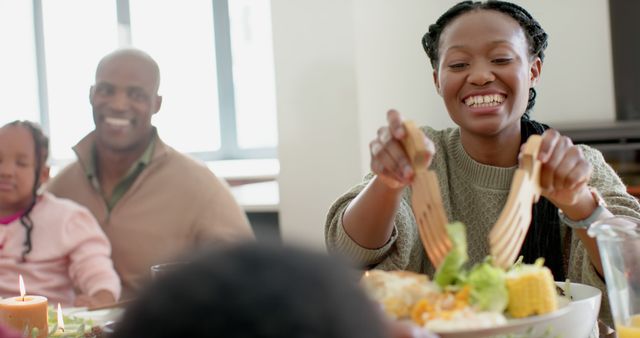 African american parents, children and grandparents celebrating at thanksgiving dinner, slow motion. Thanksgiving, celebration, meal, home, family, togetherness, unaltered.