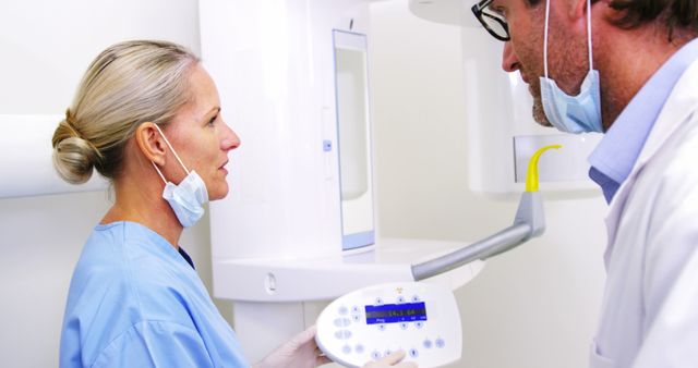 Dental Professionals Analyzing X-Ray Machine - Download Free Stock Images Pikwizard.com