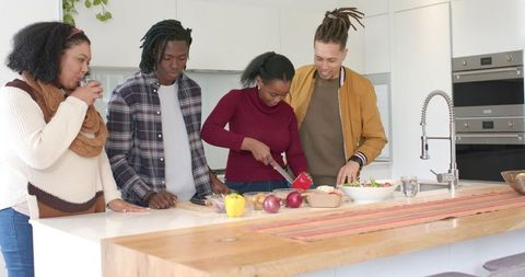 Friends Preparing Healthy Meal Together in Modern Kitchen, Chopping Vegetables