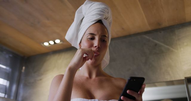 Woman in Towel Brushing Teeth While Using Smartphone - Download Free Stock Images Pikwizard.com